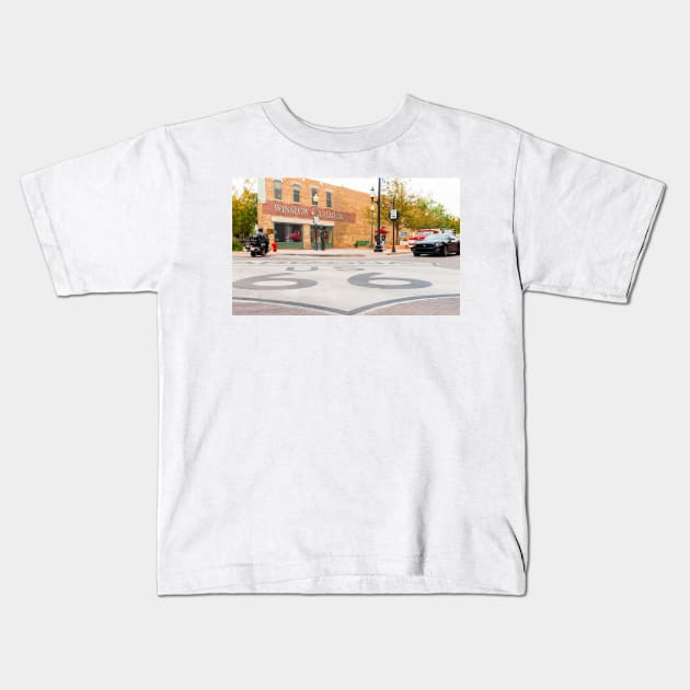 Route 66 sign on road in Winslow Arizona Kids T-Shirt by brians101